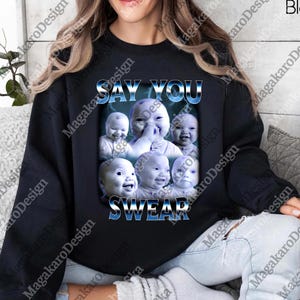 May include: A white ceramic mug with a black handle and the text "But First, Coffee" in a black, handwritten-style font. The mug is on a white surface.