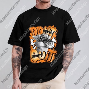 May include: Black t-shirt with an orange and white graphic. The graphic features a money bag overflowing with cash, with the words "DON'T QUIT" in an orange graffiti style. Dollar signs are also included in the design.