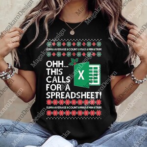 May include: Black t-shirt with a festive design featuring the text "OHH... THIS CALLS FOR A SPREADSHEET!" and an Excel spreadsheet graphic. The design includes holiday-themed elements like holly and decorative borders.