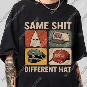 May include: Black t-shirt featuring the text "SAME SHIT DIFFERENT HAT" above four images. These include a KKK hood, a Confederate flag hat, a military hat, and a "Make America Great Again" hat.