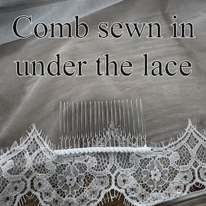 May include: Close-up of a white bridal veil with a delicate lace trim. The text "Comb sewn in under the lace" is visible. A clear comb is sewn into the veil for secure placement in the hair.