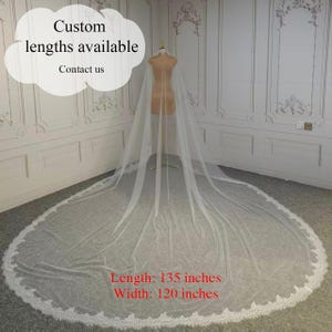 May include: A long, white bridal veil with a delicate lace trim. The veil is displayed on a mannequin, showcasing its length and design. The text "Custom lengths available, Contact us" is visible in the image. The veil is 135 inches long and 120 inches wide.