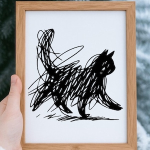 May include: A framed art print featuring a black cat illustration. The cat is depicted in a scribbled style, with a solid black silhouette and a long tail. The frame is made of light brown wood.