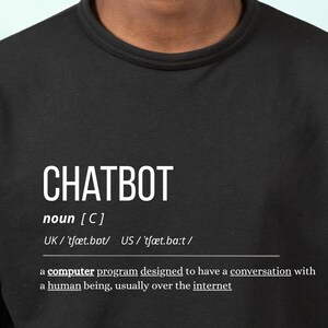 May include: A black long-sleeve sweatshirt featuring white text that defines the word CHATBOT as a noun, including phonetic pronunciations and the definition: a computer program designed to have a conversation with a human being, usually over the internet.