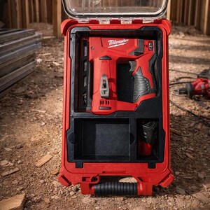 May include: A red Milwaukee power tool set in a red carrying case with a clear lid. The set includes a red and black nail gun and a black battery. The case is open, revealing the tools inside.