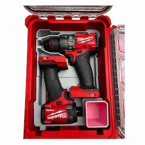 May include: A red Milwaukee FUEL power tool kit with two cordless drills and a pink accessory container. The tools are black and red, and are housed in a red case with a clear lid. The case is open, revealing the tools and accessories.