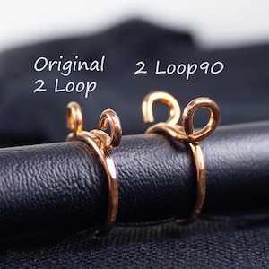May include: Two copper-colored wire rings with a looped design. The rings are displayed on a black surface. Text in white reads "Original 2 Loop" and "2 Loop 90".