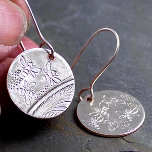 Silver earrings delicately stamped with bees on the surface adds a touch of whimsy and charm, adorable contemporary earrings for gardeners