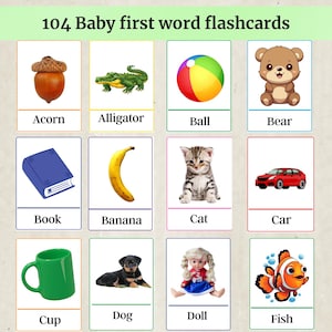 May include: A set of 104 baby first word flashcards. Each card features a colorful illustration and the corresponding word. The cards include images of an acorn, alligator, ball, bear, book, banana, cat, car, cup, dog, doll, and fish.