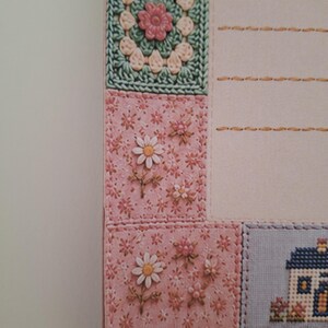 May include: A stationery sheet featuring a patchwork-style border with a crochet-look square, pink floral fabric patterns, and a small house illustration. The page includes horizontal stitched lines for writing and a white lace trim at the bottom edge.
