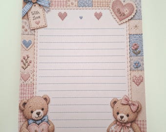 May include: A rectangular sheet of stationery featuring lined paper with a scalloped border. The design includes a patchwork pattern of blue and pink squares, two teddy bears, small hearts, and a tag with a blue bow reading With Love.