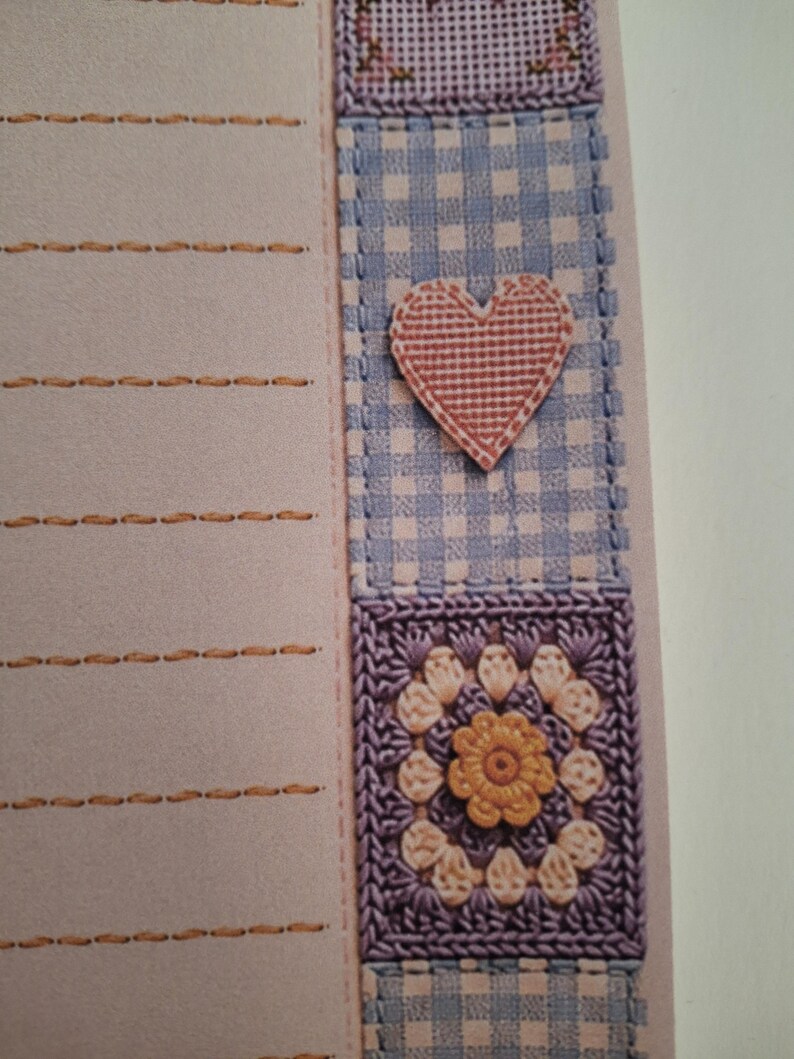 May include: A light pink stationery sheet with horizontal orange stitched lines on the left side. The right border features a vertical strip of blue and white gingham fabric, a pink heart applique, and a square purple crochet flower motif.