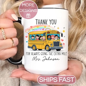 May include: White ceramic mug with a black handle and rim, featuring a yellow school bus illustration with children and the text "THANK YOU FOR ALWAYS GOING THE EXTRA MILE Mrs. Johnson".