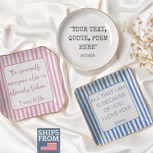 May include: Three ceramic trinket dishes with gold-toned rims. One round dish features the text "YOUR TEXT, QUOTE, POEM HERE" and "AUTHOR". Two square dishes feature pink and blue stripes with quotes by Oscar Wilde and "EMMA".