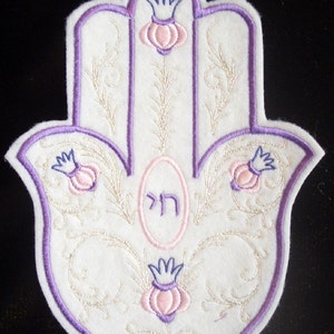 Elegant embroidered hamsa with silver swirls and pink and purple accents iron on patch