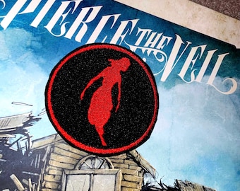 May include: A black and red embroidered patch with a silhouette of a woman in a red dress. The patch is circular and has the band name "Pierce The Veil" written in white lettering on the background.