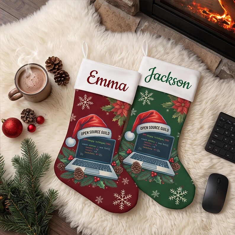 May include: Two Christmas stockings, one red and one green, featuring a white cuff with the names Emma and Jackson. Each stocking displays a laptop graphic wearing a Santa hat with the text Open Source Guild, surrounded by pine and snowflakes.