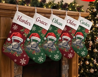 May include: Five Christmas stockings with white cuffs featuring the names Hunter, Grace, Ethan, Chloe, and Carter. The stockings are red or green with a printed graphic of a kettlebell wearing a Santa hat, surrounded by pine and poinsettias.