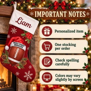 May include: A red Christmas stocking with a white cuff personalized with the name Liam. The stocking features a brown football wearing a Santa hat with the text West Coast Grizzlies, surrounded by pine cones, holly, and white snowflakes.