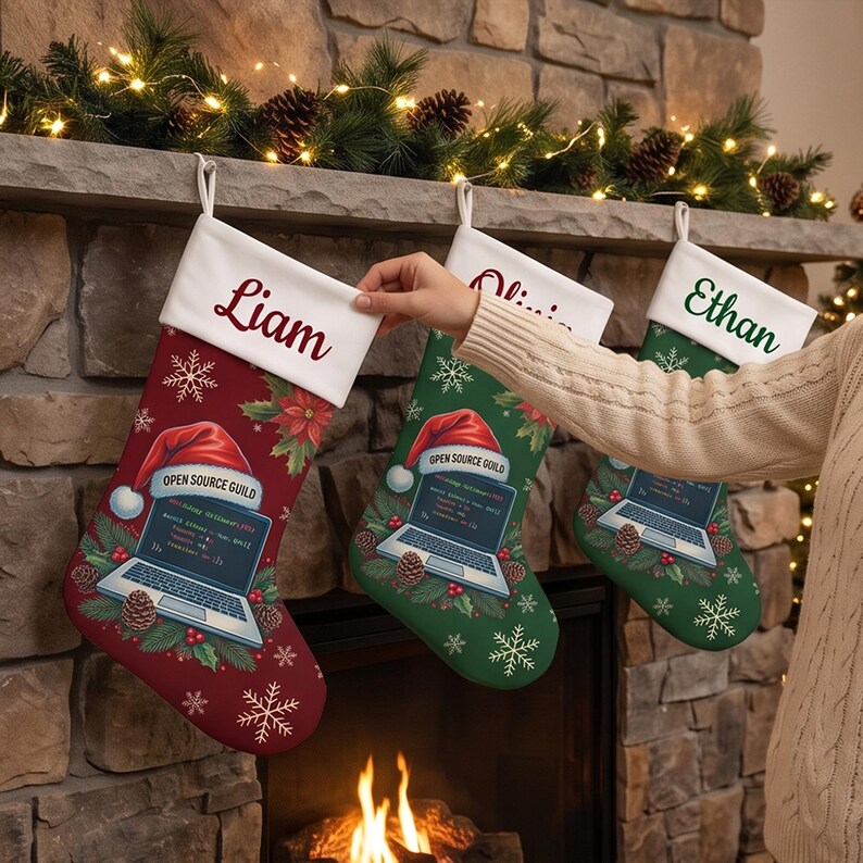 May include: Three Christmas stockings with white cuffs featuring the names Liam, Olivia, and Ethan. The stockings are decorated with snowflakes, pine cones, and a graphic of a laptop displaying the text Open Source Guild.