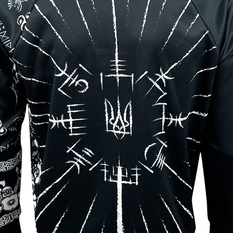 May include: Black sweatshirt with a white print of a Ukrainian trident surrounded by stylized symbols. The print is centered on the chest of the sweatshirt.