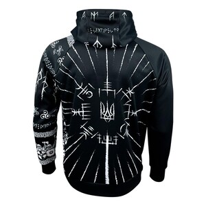 May include: Black hoodie with a white design featuring a Ukrainian trident and various symbols. The hoodie has a drawstring hood and a zipper closure.