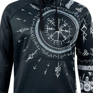 May include: Black hooded sweatshirt with a white print of a compass and other symbols. The print is a stylized design of Norse runes and other symbols.