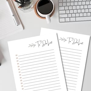 May include: Two white paper sheets featuring the text To Do List in black script, accompanied by a small leaf illustration. Each sheet includes a column of light pink square checkboxes followed by horizontal black lines for writing.