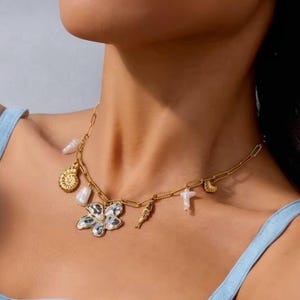 Gold necklace with pearly flower pendant and original marine charms – shell, fish, coral – summer jewelry in steel