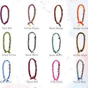 May include: A collection of graduation leis in various color combinations, including navy and red, yellow and purple, and black and orange. Each lei features the year "2024" and a decorative bow.