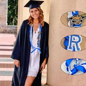 May include: A person wearing a graduation cap and gown, with a blue and white graduation lei. The lei has the year 2025 on it. Additional graduation-themed items are shown in oval frames.