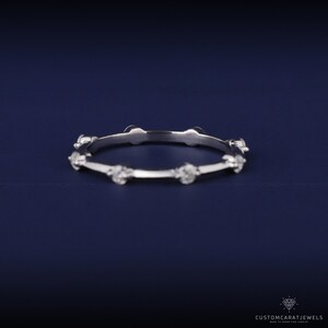 Side view of white gold diamond station band highlighting brilliance and smooth gold band.
side view ring, diamond placement, white gold shine, stacking ring, minimalist elegance, dainty band, wedding ring, anniversary gift, eternity style, bridal accessory, fine jewelry, sparkle clarity, gold band, elegant design, modern ring