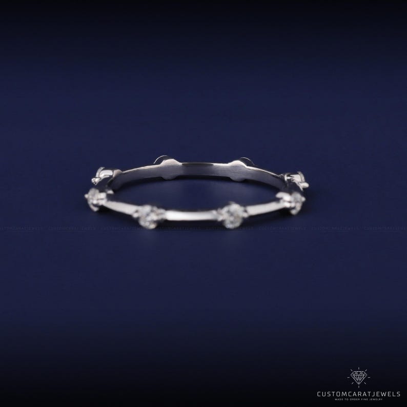 Side view of white gold diamond station band highlighting brilliance and smooth gold band.
side view ring, diamond placement, white gold shine, stacking ring, minimalist elegance, dainty band, wedding ring, anniversary gift, eternity style, bridal accessory, fine jewelry, sparkle clarity, gold band, elegant design, modern ring