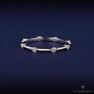 Close-up of diamond station band in 14K white gold showing precise diamond placement and polished finish.
diamond clarity, station design, white gold band, elegant sparkle, dainty ring, stacking band, wedding accessory, anniversary ring, fine jewelry, everyday elegance, bridal band, gold polish, minimalist style, subtle ring, ring detai