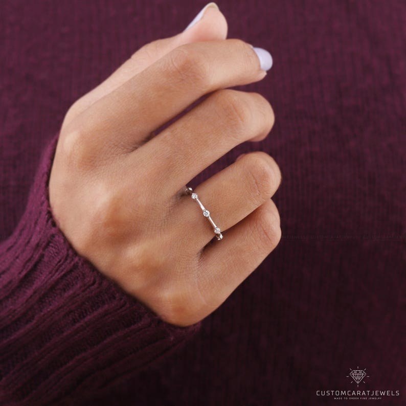 Top-down view of diamond station ring in white gold, showing symmetry and delicate brilliance.
top view ring, diamond clarity, station placement, white gold band, stacking ring, wedding band, eternity design, minimalist ring, bridal jewelry, fine accessory, elegant sparkle, subtle design, chic band, dainty elegance, classic ring