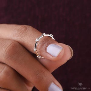 Flatlay of diamond station ring with bridal accessories and gold elements for wedding inspiration.
flatlay ring, diamond sparkle, white gold band, station design, bridal inspiration, wedding accessory, fine jewelry, stacking ring, dainty design, elegant look, gold clarity, subtle ring, everyday sparkle, chic band, anniversary gift