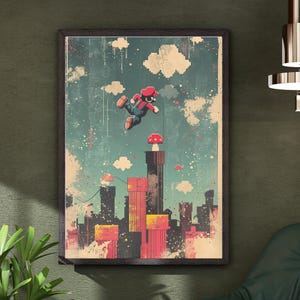 May include: A framed art print depicting a pixelated character in a red hat and overalls, mid-jump above a cityscape. The artwork has a vintage aesthetic with a teal sky, white clouds, and red and yellow buildings. The print is in a dark wooden frame.