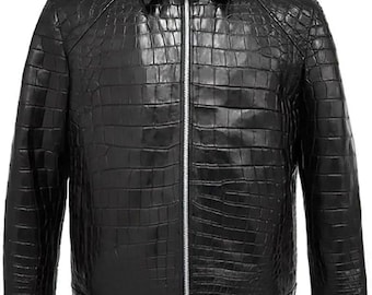 May include: A black leather jacket with a crocodile skin texture. The jacket has a collared neckline, a silver zipper closure, and long sleeves. The jacket's design is a classic, timeless style.