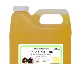May include: A clear plastic gallon jug filled with a light yellow liquid. The label reads "Dr Adorable Inc. Cacay Nut Oil 100% Pure Organic Natural Unrefined 32 oz. Botanical Name Caryodendron orinocense Method Cold Pressed Country Brazil Exp date www.dradorable.com".