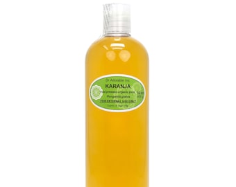 May include: A clear glass bottle with a yellow liquid inside. The bottle has a green label that reads "Dr Adorable Inc KARANJA cold pressed organic pure 16 oz Pongamia glabra 455 g FOR EXTERNAL USE ONLY Country of origin India".