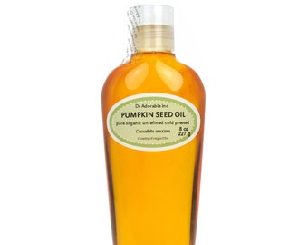 May include: A clear glass bottle of 8 ounce (227 gram) pumpkin seed oil. The label is green and white with the text "Dr Adorable Inc Pumpkin Seed Oil pure organic unrefined cold pressed Cucurbita maxima Country of origin USA".