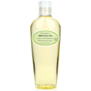 May include: A clear bottle of Dr. Adorable Inc. Broccoli Oil. The label is oval-shaped with a light green border and features the text "BROCCOLI OIL" and "organic cold pressed pure". The bottle contains 8 oz (227 g) of oil.