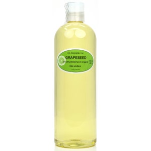 May include: A clear glass bottle of 16 ounce (445 gram) organic grapeseed oil. The bottle has a green label with the text "GRAPESEED 100% cold pressed pure organic Vitis vinifera" and the company name "Dr Adorable Inc."