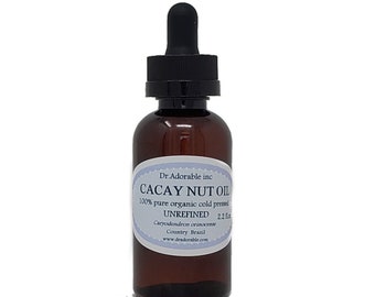 Könnte beinhalten: Eine braune Glasflasche mit Tropfer, beschriftet mit "CACAY NUT OIL 100% pure organic cold pressed UNREFINED 2.2 fl oz Caryodendron orinocense Country Brazil www.dradorable.com"