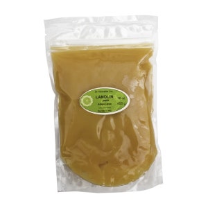 May include: A clear plastic bag filled with a yellow lanolin product. The bag has a label that reads "LANOLIN pure Adip. Lanae 16 oz 455 g Dr. Adorable Inc."
