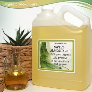 May include: A clear plastic jug of 100% pure organic sweet almond oil, cold pressed for hair, skin, and body. The jug is labeled "Dr Adorable Inc Sweet Almond Oil 100% pure organic cold pressed for hair skin & body multi purpose 7 lb".