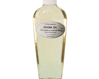 May include: A clear glass bottle of 8 ounce (227 gram) cold-pressed, pure refined jojoba oil. The bottle has a white label with the text "Dr Adorable Inc JOJOBA OIL cold pressed pure refined clear 8 oz 227 g Simmondsia chinensis Country of origin: India Exp. date: 12.2016".