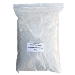 May include: A white plastic bag filled with white emulsifying wax flakes. The bag has a label that reads "Dr. Adorable Inc. Emulsifying Wax NF Polysorbate 60/ Polawax 1 lb."