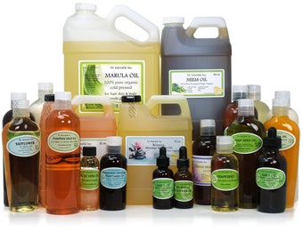 May include: A collection of 17 amber glass bottles containing various oils, including Marula Oil, Neem Oil, Pumpkin Seed Oil, Hemp Seed Oil, and Amla Oil. The bottles are arranged in rows on a white surface. The bottles are labeled with the type of oil and the brand name, Dr. Adorable Inc.
