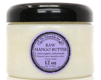 May include: A white jar with a black lid containing raw mango butter. The label is purple with black text that reads "Dr. Adorable Inc. RAW MANGO BUTTER pure organic cold pressed Botanical name. Mangifera indica Country. India 100% natural www.dradorable.com 12 oz exp 12.202"